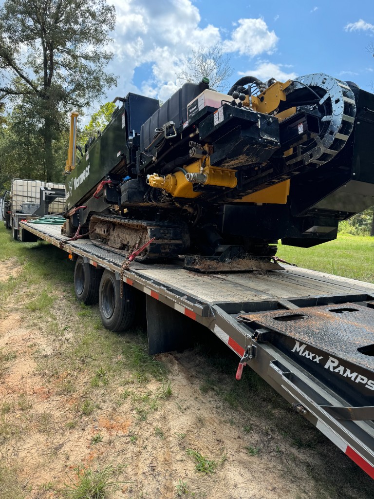 Vermeer directional drill secured on a flatbed transport trailer